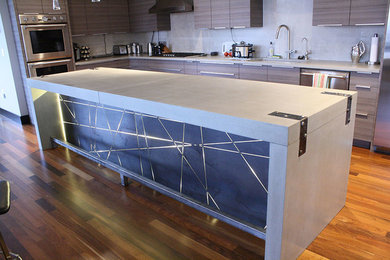 Inspiration for a modern kitchen remodel in Minneapolis with recessed-panel cabinets and concrete countertops
