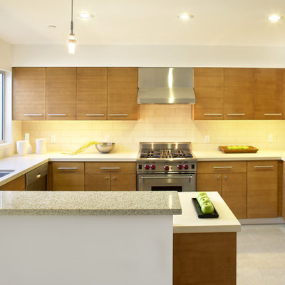 Mid-sized minimalist u-shaped ceramic tile and beige floor enclosed kitchen photo in San Francisco with stainless steel appliances, a single-bowl sink, flat-panel cabinets, medium tone wood cabinets, quartzite countertops, white backsplash, subway tile backsplash and a peninsula