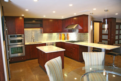 Example of a large minimalist l-shaped concrete floor eat-in kitchen design in Columbus with an undermount sink, flat-panel cabinets, dark wood cabinets, marble countertops, metallic backsplash, subway tile backsplash, stainless steel appliances and an island