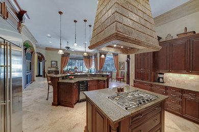 Kitchen - traditional u-shaped kitchen idea in Miami with granite countertops, stainless steel appliances and two islands