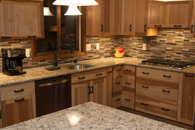 Mid-sized arts and crafts l-shaped light wood floor and brown floor eat-in kitchen photo in Minneapolis with a single-bowl sink, recessed-panel cabinets, medium tone wood cabinets, quartz countertops, multicolored backsplash, glass tile backsplash, stainless steel appliances and a peninsula