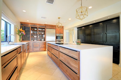 Large minimalist l-shaped travertine floor and beige floor eat-in kitchen photo in Phoenix with a farmhouse sink, shaker cabinets, medium tone wood cabinets, quartzite countertops, white backsplash, subway tile backsplash, stainless steel appliances and an island