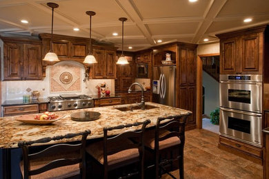 Inspiration for a large timeless porcelain tile eat-in kitchen remodel in St Louis with a double-bowl sink, raised-panel cabinets, medium tone wood cabinets, granite countertops, beige backsplash, ceramic backsplash, stainless steel appliances and an island