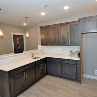 Design ideas for a mid-sized traditional l-shaped open plan kitchen in Other with an undermount sink, shaker cabinets, dark wood cabinets, quartz benchtops, white splashback, porcelain splashback, stainless steel appliances, vinyl floors and a peninsula.