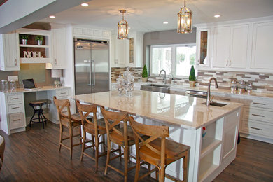 Eat-in kitchen - large transitional l-shaped medium tone wood floor eat-in kitchen idea in Columbus with a farmhouse sink, beaded inset cabinets, white cabinets, granite countertops, multicolored backsplash, stainless steel appliances and an island