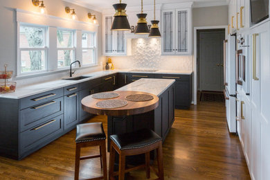 Eat-in kitchen - mid-sized transitional medium tone wood floor and brown floor eat-in kitchen idea in Cincinnati with an undermount sink, recessed-panel cabinets, quartz countertops, white backsplash, ceramic backsplash, white appliances, an island and white countertops