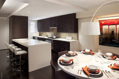 Example of a minimalist galley eat-in kitchen design in New York with flat-panel cabinets, dark wood cabinets, beige backsplash and stainless steel appliances