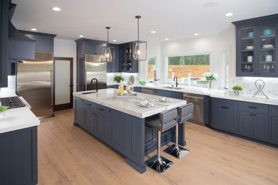 Inspiration for a transitional u-shaped kitchen remodel in San Francisco with beaded inset cabinets and black cabinets