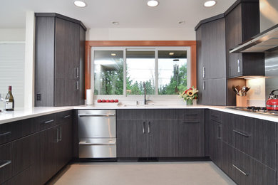 Example of a mid-sized trendy u-shaped concrete floor and gray floor open concept kitchen design in Portland with an undermount sink, flat-panel cabinets, gray cabinets, quartzite countertops, white backsplash, stone slab backsplash, stainless steel appliances and a peninsula