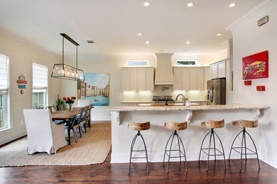 Inspiration for a large timeless u-shaped medium tone wood floor eat-in kitchen remodel in New Orleans with an undermount sink, recessed-panel cabinets, white cabinets, granite countertops, white backsplash, subway tile backsplash, stainless steel appliances and an island