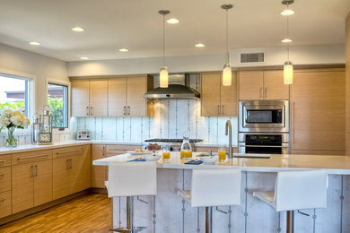 Inspiration for a contemporary l-shaped medium tone wood floor kitchen remodel in San Diego with an undermount sink, flat-panel cabinets, medium tone wood cabinets, quartz countertops, multicolored backsplash, stone tile backsplash, paneled appliances and an island