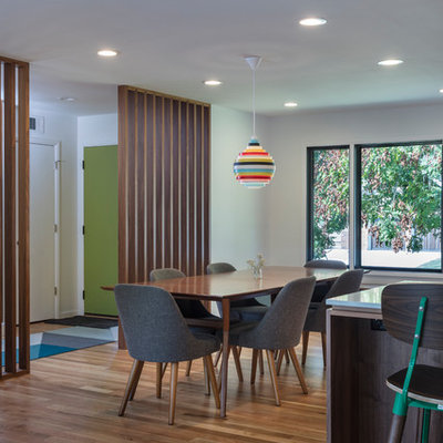 Mid-sized 1960s u-shaped light wood floor eat-in kitchen photo in Kansas City with an undermount sink, flat-panel cabinets, blue cabinets, quartz countertops, white backsplash, ceramic backsplash, stainless steel appliances and a peninsula