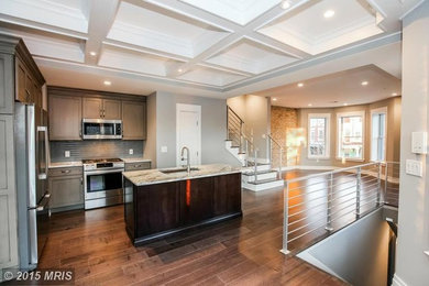Mid-sized transitional l-shaped medium tone wood floor eat-in kitchen photo in DC Metro with a single-bowl sink, shaker cabinets, gray cabinets, stainless steel appliances and an island