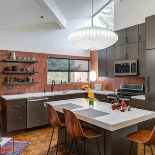 Design ideas for a mid-sized midcentury l-shaped eat-in kitchen in San Francisco with an undermount sink, flat-panel cabinets, dark wood cabinets, brown splashback, stainless steel appliances, medium hardwood floors, with island, brown floor and white benchtop.