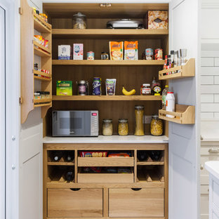 Design ideas for a medium sized classic kitchen pantry in Essex with white worktops and light hardwood flooring.
