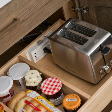 A Breakfast Center Station in a Base Cabinet with Powered Roll-Out Shelves