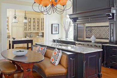 Inspiration for a huge timeless single-wall medium tone wood floor and beige floor eat-in kitchen remodel in Charleston with a single-bowl sink, raised-panel cabinets, granite countertops, beige backsplash, ceramic backsplash, stainless steel appliances, two islands and gray cabinets