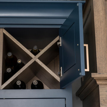 A Close Up of Hickory and Gale Force Blue Painted Cabinets with a Double X Wine