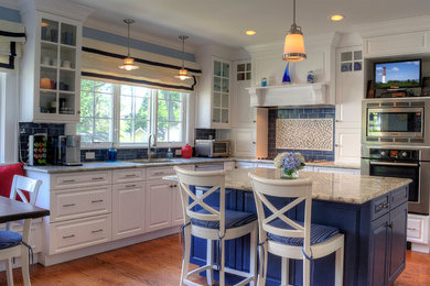 Kitchen - traditional kitchen idea in Newark with raised-panel cabinets, white cabinets, blue backsplash, subway tile backsplash, stainless steel appliances and marble countertops