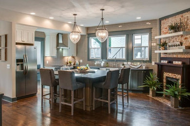 Example of a mid-sized transitional l-shaped dark wood floor and brown floor eat-in kitchen design in Nashville with a farmhouse sink, shaker cabinets, white cabinets, concrete countertops, gray backsplash, ceramic backsplash, stainless steel appliances, an island and gray countertops