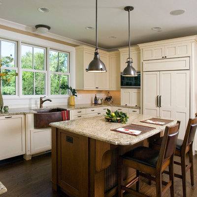 Kitchen - craftsman u-shaped kitchen idea in Chicago with a farmhouse sink, shaker cabinets, beige cabinets, granite countertops, white backsplash, subway tile backsplash and paneled appliances