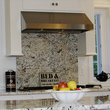 A full length granite backsplash over the stove
