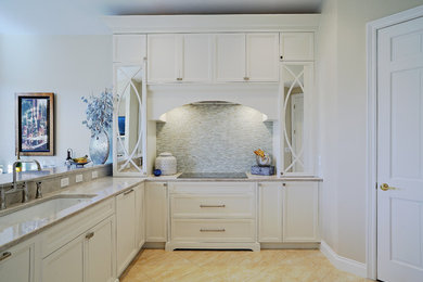 Eat-in kitchen - mid-sized transitional l-shaped eat-in kitchen idea in Miami with a double-bowl sink, recessed-panel cabinets, white cabinets, quartzite countertops, white backsplash, glass tile backsplash, paneled appliances and a peninsula