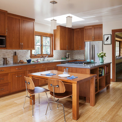 Example of a mid-sized arts and crafts l-shaped bamboo floor and beige floor eat-in kitchen design in San Francisco with shaker cabinets, medium tone wood cabinets, stainless steel appliances, an island, quartz countertops, beige backsplash and ceramic backsplash