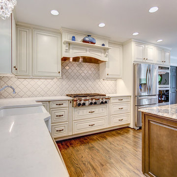 A Kitchenaid Gas Range Top is vented with a custom built hood.