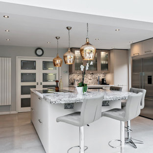 Contemporary kitchen in Berkshire with granite worktops, an island, flat-panel cabinets, grey cabinets, stainless steel appliances, grey floors and multicoloured worktops.
