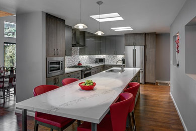 Eat-in kitchen - mid-sized contemporary l-shaped medium tone wood floor eat-in kitchen idea in San Francisco with an undermount sink, flat-panel cabinets, gray cabinets, quartz countertops, red backsplash, porcelain backsplash, stainless steel appliances and an island