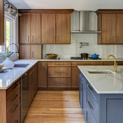 Large minimalist l-shaped medium tone wood floor and brown floor open concept kitchen photo in Chicago with an undermount sink, flat-panel cabinets, medium tone wood cabinets, quartz countertops, white backsplash, subway tile backsplash, stainless steel appliances, an island and white countertops
