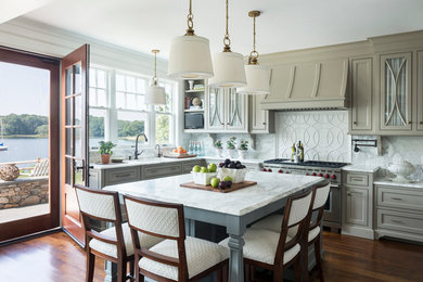 Example of an ornate dark wood floor kitchen design in Providence with an undermount sink, shaker cabinets, gray cabinets, white backsplash, stainless steel appliances and an island