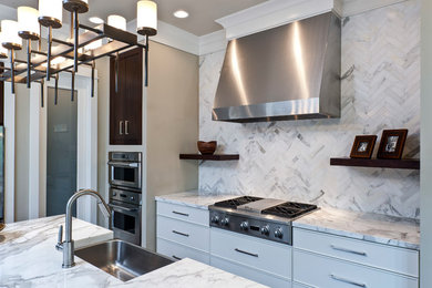 Mid-sized trendy l-shaped dark wood floor and brown floor open concept kitchen photo in Indianapolis with a farmhouse sink, flat-panel cabinets, white cabinets, marble countertops, white backsplash, porcelain backsplash, stainless steel appliances and an island