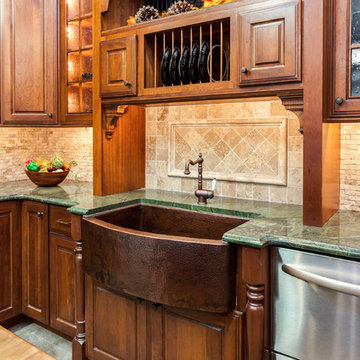 A Pounded Copper Farm Sink shines in this JM Kitchen & Bath's Denver Cabinet, Co