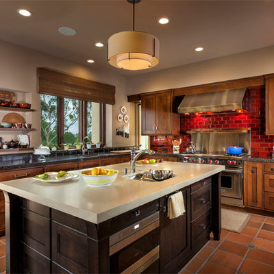 Inspiration for a transitional l-shaped kitchen remodel in Orange County with an undermount sink, shaker cabinets, dark wood cabinets, red backsplash, subway tile backsplash and stainless steel appliances