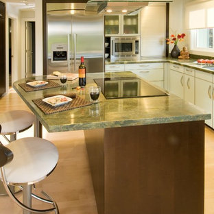 Inspiration for a contemporary l-shaped eat-in kitchen remodel in Hawaii with glass-front cabinets, stainless steel appliances, an undermount sink, granite countertops, green backsplash and green countertops