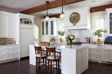 Example of a large classic u-shaped dark wood floor eat-in kitchen design in Denver with a drop-in sink, recessed-panel cabinets, white cabinets, marble countertops, white backsplash, subway tile backsplash, stainless steel appliances and an island