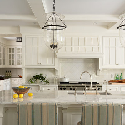 Eat-in kitchen - huge traditional eat-in kitchen idea in Minneapolis with an undermount sink, beaded inset cabinets, white cabinets, marble countertops, white backsplash, subway tile backsplash, stainless steel appliances and an island