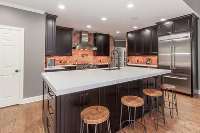 Transitional kitchen photo in Atlanta with flat-panel cabinets, black cabinets and an island