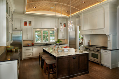 Eat-in kitchen - traditional l-shaped medium tone wood floor and brown floor eat-in kitchen idea in Other with an undermount sink, shaker cabinets, white cabinets, soapstone countertops, white backsplash, subway tile backsplash, stainless steel appliances and an island