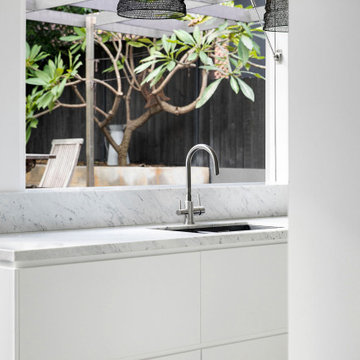 Modern grey kitchen with marble benchtops and splashback