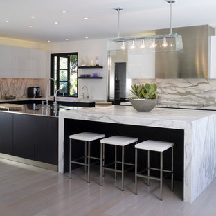 Design ideas for a large contemporary l-shaped kitchen in Los Angeles with an integrated sink, flat-panel cabinets, white cabinets, stainless steel benchtops, panelled appliances, with island, grey splashback, marble splashback and light hardwood floors.