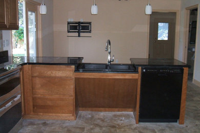 Example of a mid-sized classic l-shaped linoleum floor eat-in kitchen design in Orlando with a double-bowl sink, raised-panel cabinets, medium tone wood cabinets, granite countertops, stainless steel appliances, beige backsplash and ceramic backsplash