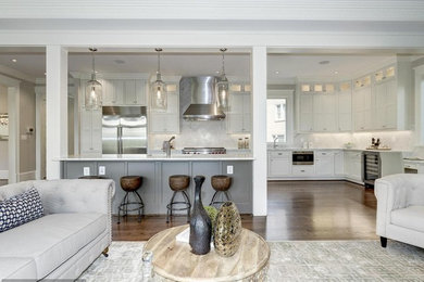 Eat-in kitchen - mid-sized transitional l-shaped medium tone wood floor eat-in kitchen idea in DC Metro with an undermount sink, shaker cabinets, white cabinets, quartz countertops, gray backsplash, stainless steel appliances, subway tile backsplash and an island