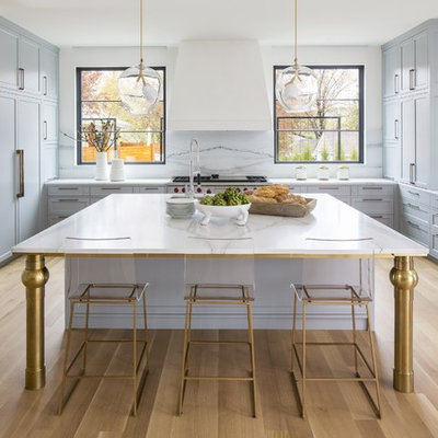 Example of a large transitional u-shaped light wood floor and beige floor open concept kitchen design in DC Metro with shaker cabinets, gray cabinets, marble countertops, white backsplash, marble backsplash, paneled appliances, an island, white countertops and an undermount sink