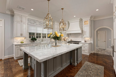 Large elegant u-shaped dark wood floor and brown floor eat-in kitchen photo in DC Metro with a farmhouse sink, recessed-panel cabinets, white cabinets, multicolored backsplash, stainless steel appliances, an island, multicolored countertops, marble countertops and mosaic tile backsplash