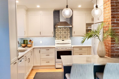 Small transitional light wood floor and yellow floor eat-in kitchen photo with an undermount sink, shaker cabinets, white cabinets, quartz countertops, blue backsplash, ceramic backsplash, white appliances, a peninsula and white countertops