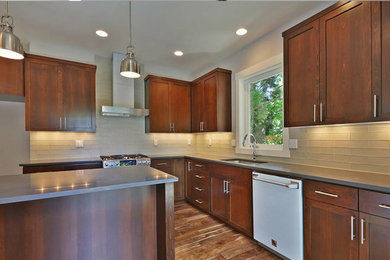 Eat-in kitchen - contemporary l-shaped eat-in kitchen idea in Portland with an undermount sink, quartzite countertops, beige backsplash, glass tile backsplash and stainless steel appliances