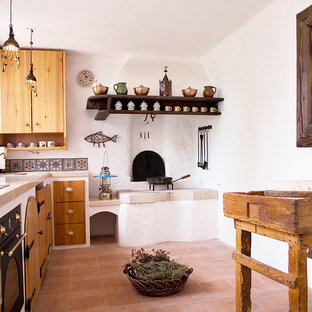 Small mediterranean u-shaped eat-in kitchen in Other with an integrated sink, open cabinets, medium wood cabinets, limestone benchtops, multi-coloured splashback, ceramic splashback, white appliances, no island and terra-cotta floors.